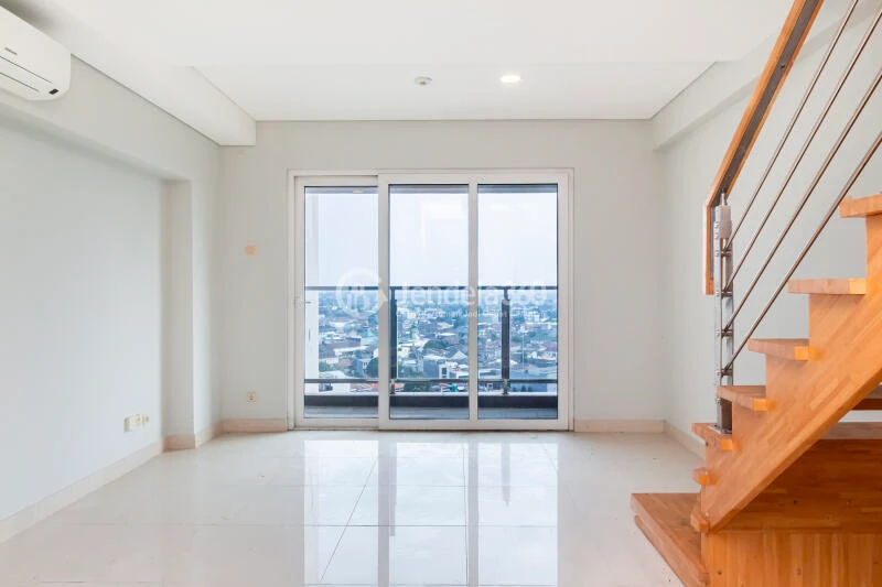 Living Room Restful 2BR Apartment Middle Floor with City View at Maqna Residence