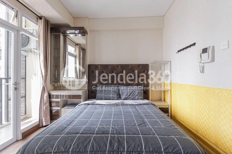 Bedroom Modest Studio Apartment with City View from Heights at Puri Orchard Apartment