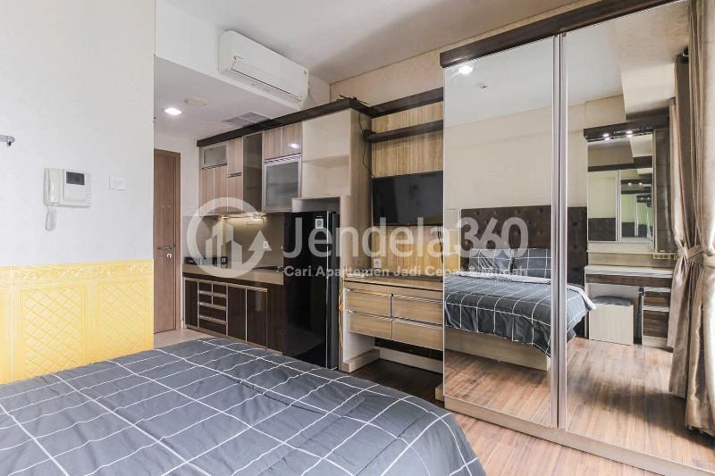 Bedroom Modest Studio Apartment with City View from Heights at Puri Orchard Apartment
