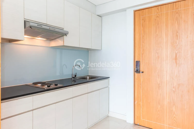 Kitchen Restful 2BR Apartment Middle Floor with City View at Maqna Residence
